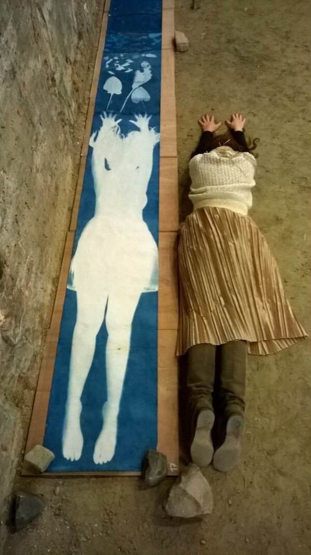 Lysiane Bourdon making a 9 meter by 1 meter cyanotype self-portrait.
